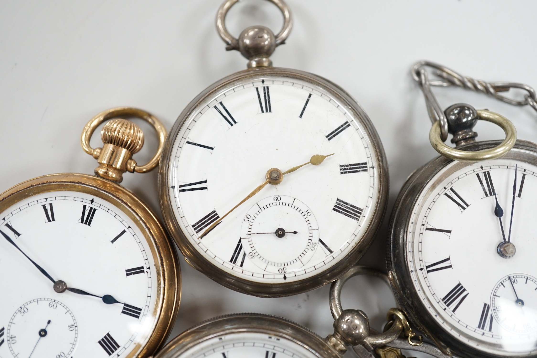 Three white metal open face pocket watches including two silver, one Waltham and a gold plated pocket watch.